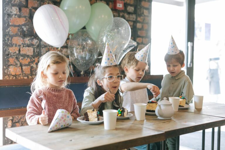 Children celebrating a birthday party with cake and balloons — why birthday celebrations matter for kids development