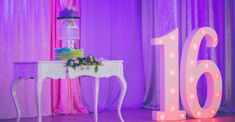 Sweet 16 birthday party celebration setup with illuminated number 16, cake, and decorations