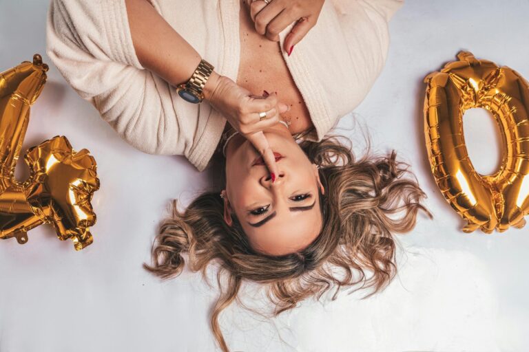 Elegant woman celebrating her 40th birthday with golden balloons and gifts, symbolising a milestone birthday celebration