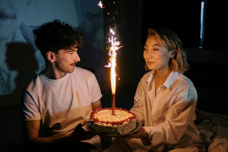 Couple celebrating birthday together with cake and sparkling candle, a warm intimate moment perfect for writing a heartfelt birthday letter for boyfriend