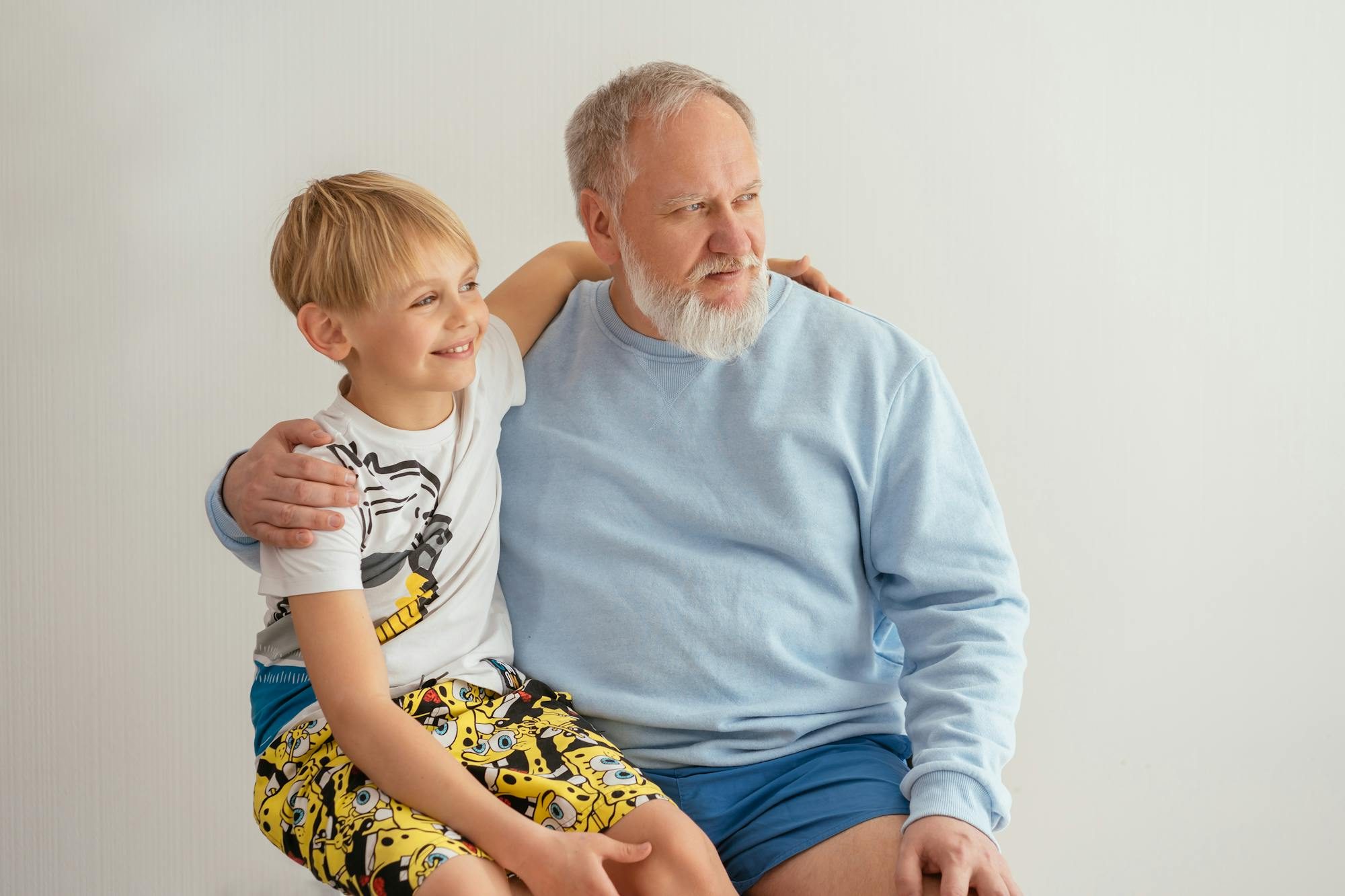 Grandparent and adult grandson sharing a warm birthday celebration together