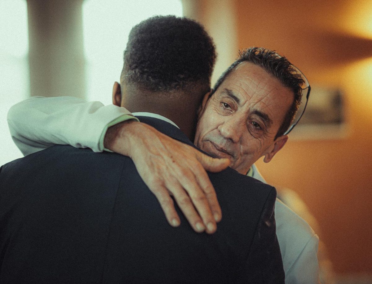 Two adults sharing a heartfelt hug, capturing the warmth of a belated birthday message that still means the world