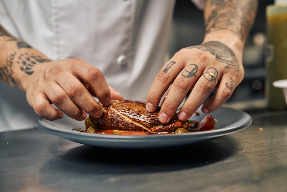 Private chef artfully plating a gourmet dinner dish for a 40th birthday celebration